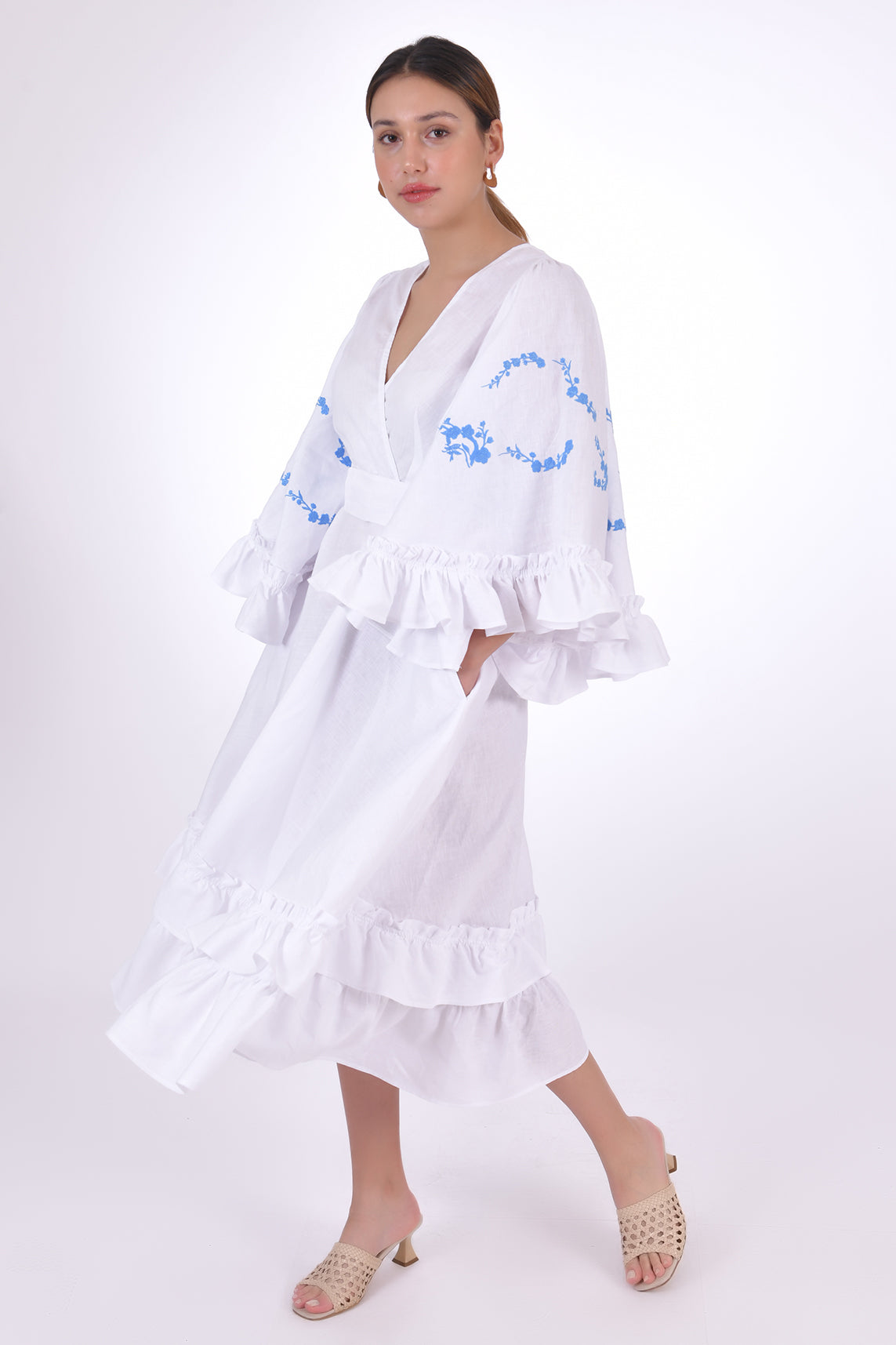 Fanm Mon Hati Linen Dress, Showcasing the movement of the Linen fabric, bell sleeves and ruffled hem. Side View.