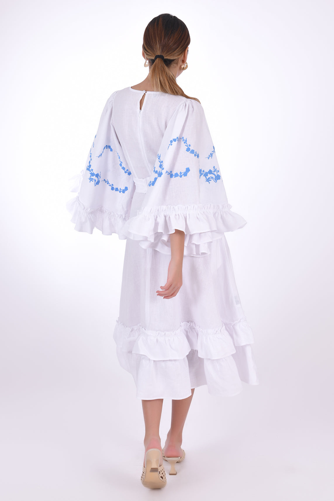 Fanm Mon Hati Midi Linen Dress, showcasing key hole closer, bell sleeves and wrap around embroidery detail. Back View.