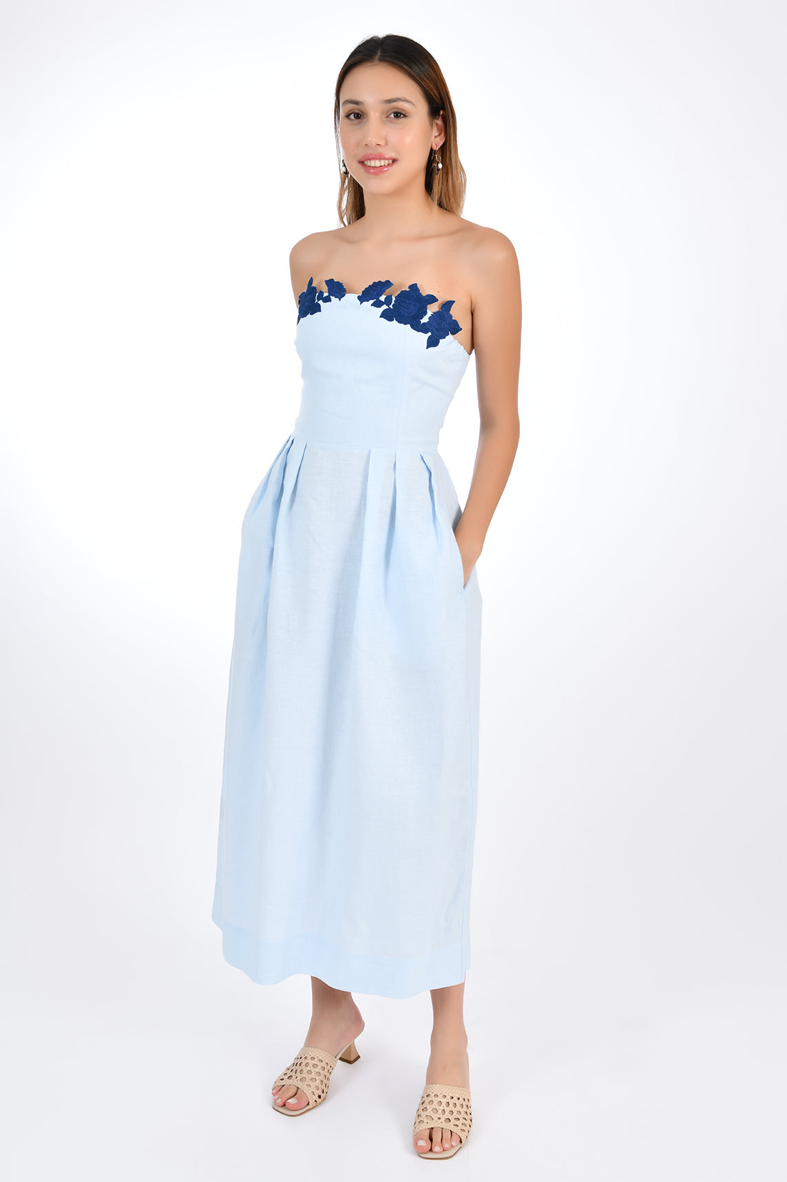 Fanm Mon Linen Lorr Dress in Light Lagoon, flaunts a sheath strapless silhouette embellished with hand-embroidered floral appliques in harmonizing hues along the neckline. Front View.