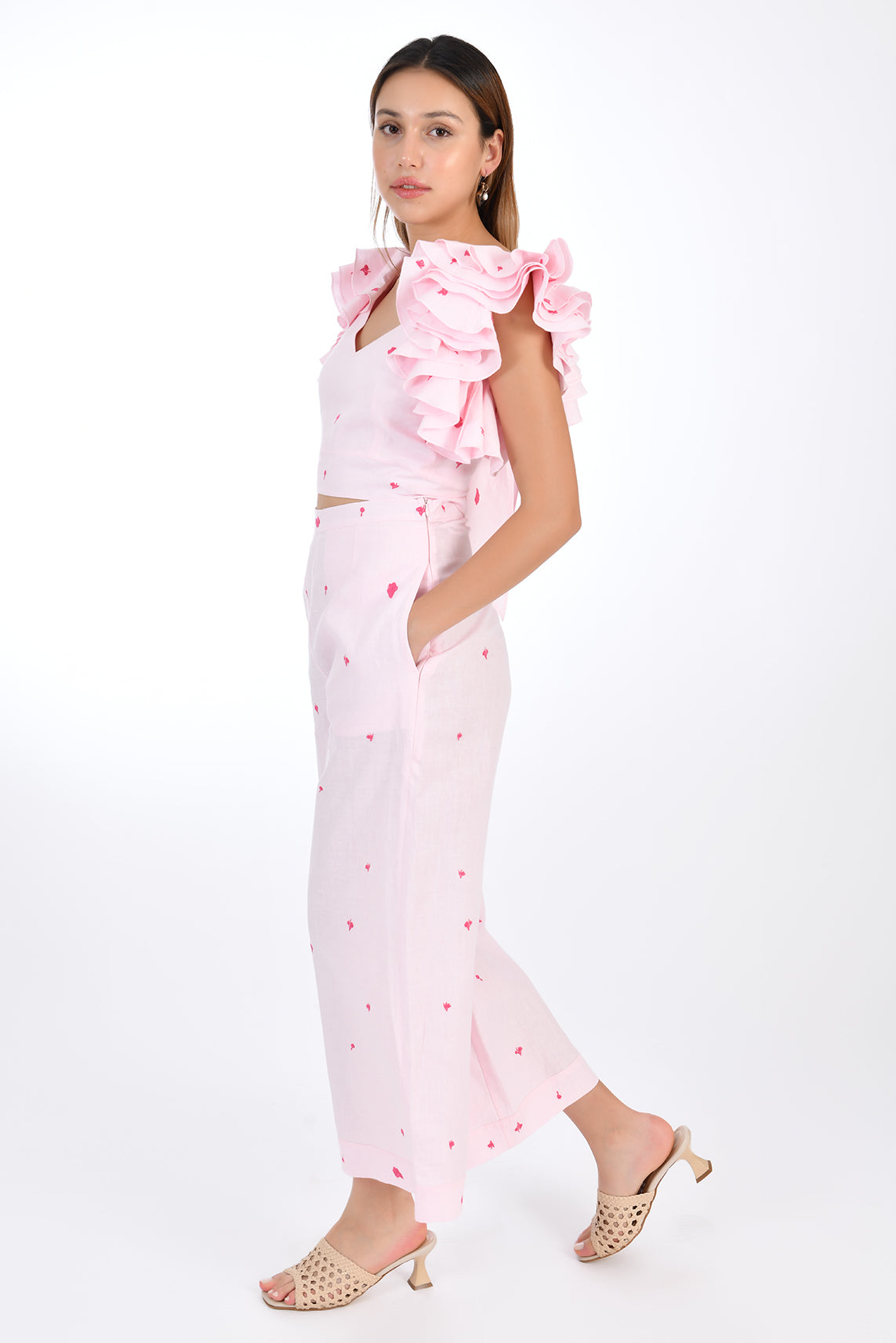 FANM MON ANAIS 2 Piece Linen Top and Pants Set. Side View, showcasing sleeveless top ruffles with intricate embroidery detail and on-seam pockets featured on wide-leg pants that boast a matching embroidery detail for a cohesive look.