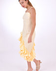 Fanm Mon Freda Midi Linen Dress, with flared asymmetrical ruffled hemline. (Side View)