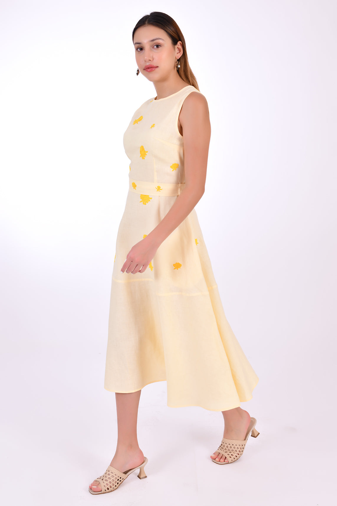 Fanm Mon Midi Linen Elvan Dress. Side View showcase movement of linen, length and floral embroidery detail. 