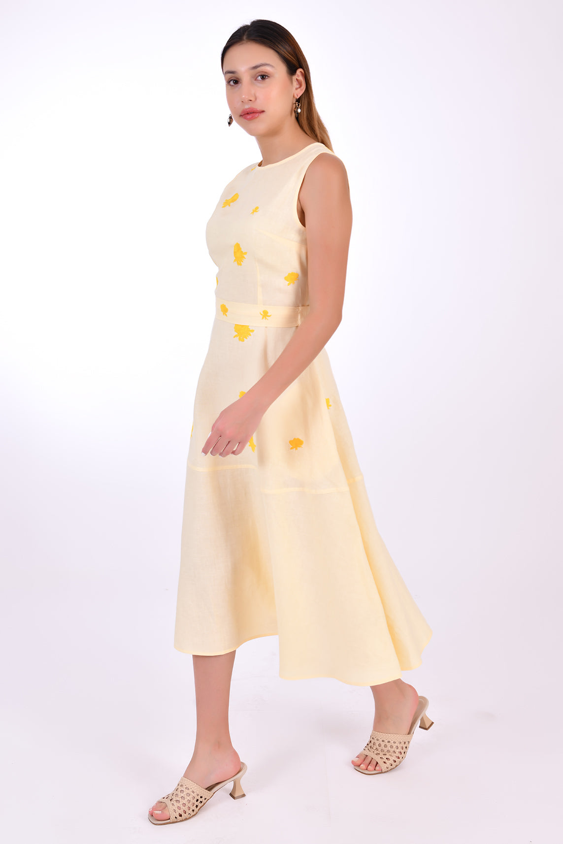 Fanm Mon Midi Linen Elvan Dress. Side View showcase movement of linen, length and floral embroidery detail.