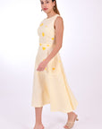 Fanm Mon Midi Linen Elvan Dress. Side View showcase movement of linen, length and floral embroidery detail.