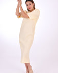 Fanm Mon Doga Midi Linen Dress, Side View (not belted). Short Sleeve 100% Linen Dress, featuring a peephole open back and button closure. Round neck, with a belt for the waist (can be worn with or without), and features front embroidery detail.