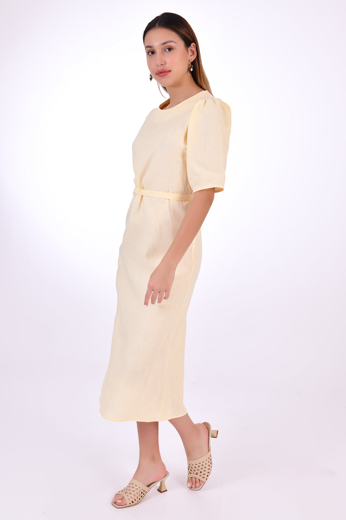 Fanm Mon Doga Midi Linen Dress, Side View Belted. Short Sleeve 100% Linen Dress, featuring a peephole open back and button closure. Round neck, with a belt for the waist (can be worn with or without), and features front embroidery detail.