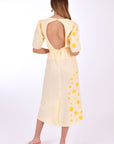 Fanm Mon Doga Midi Linen Dress, Back View Belted. Short Sleeve 100% Linen Dress, featuring a peephole open back and button closure. Round neck, with a belt for the waist (can be worn with or without), and features front embroidery detail.