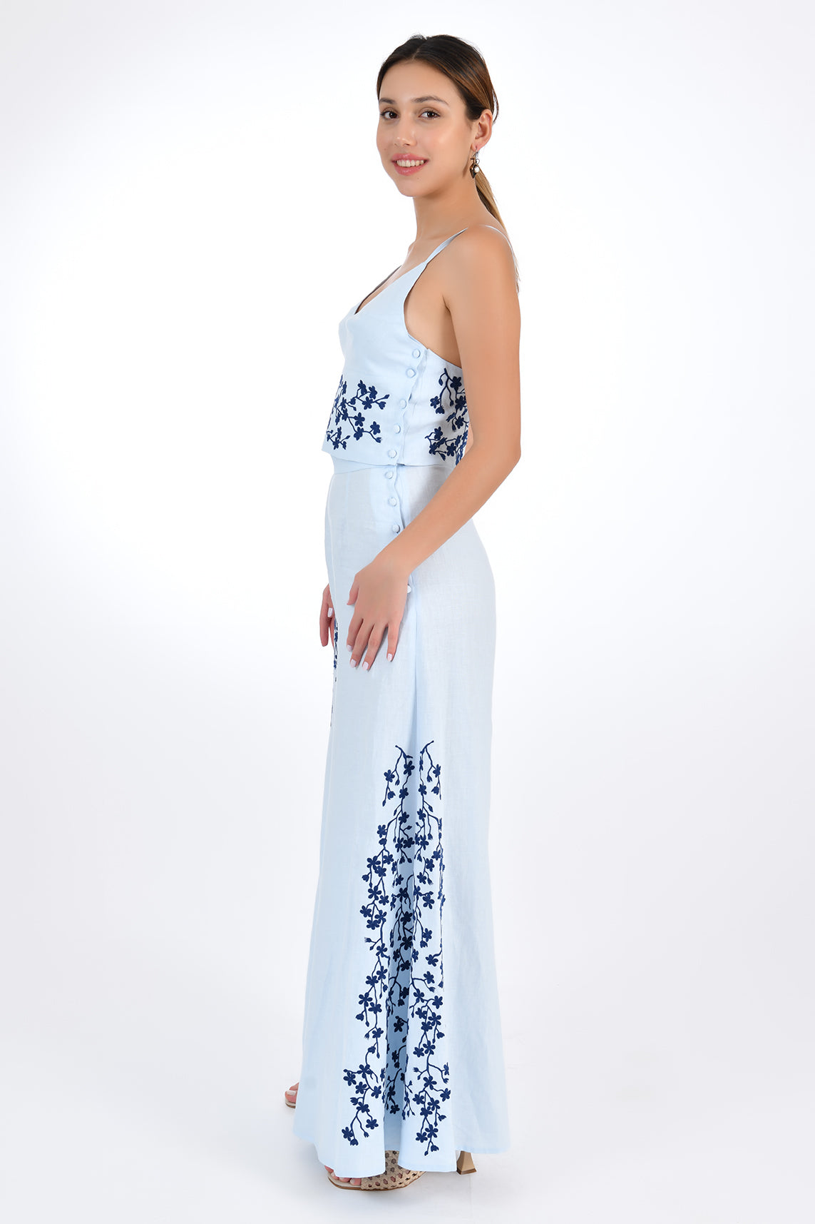 Fanm Mon Cali Linen Pant Set in Light Lagoon, side view. 2 Piece Linen Top and Pants Set. Top features intricate embroidery detail and a side button closure, while the wide-leg pants boast a matching embroidery detail and side button closure for a cohesive look.