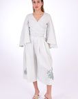 Fanm Mon Des-Vu Linen Shorts Set (Front View). 2-Piece Linen Shorts & Top Set. Featuring a wrap top with wide long sleeves and long pleated shorts with embroidery.