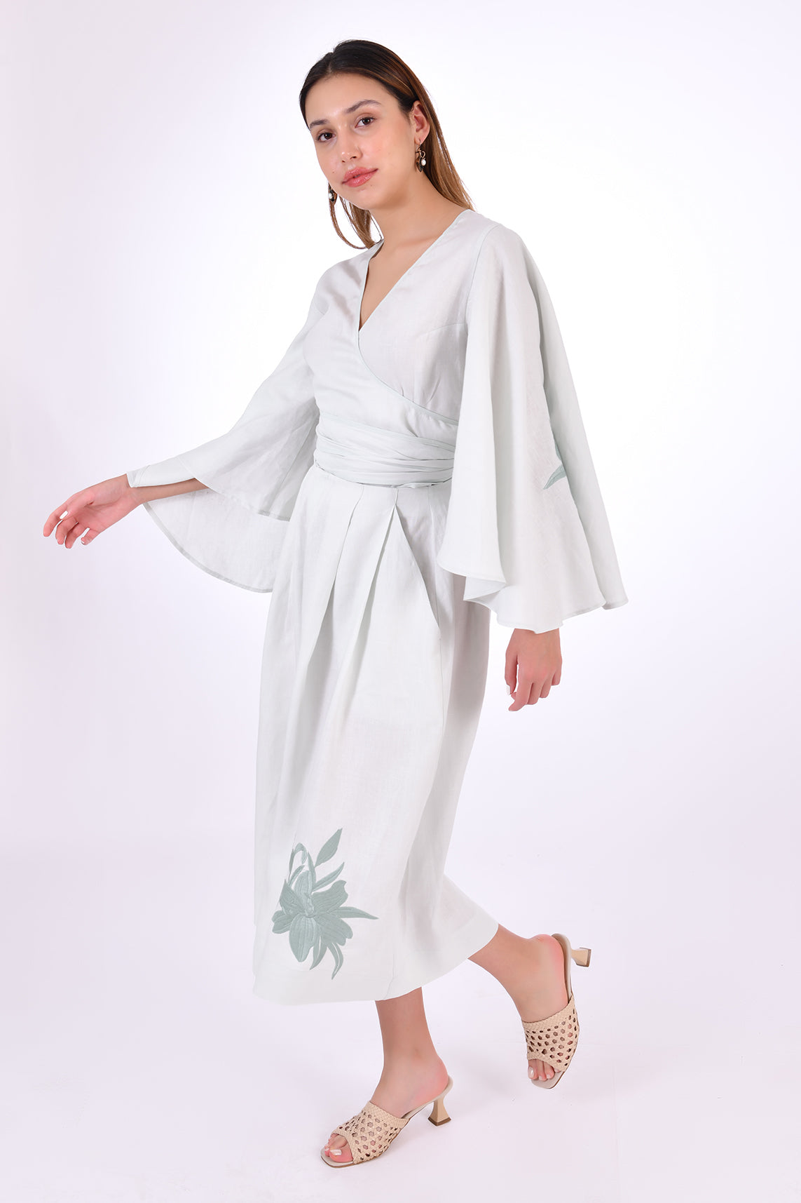Fanm Mon Des-Vu Linen Shorts Set (Side View). 2-Piece Linen Shorts & Top Set. Featuring a wrap top with wide long sleeves and long pleated shorts with embroidery.