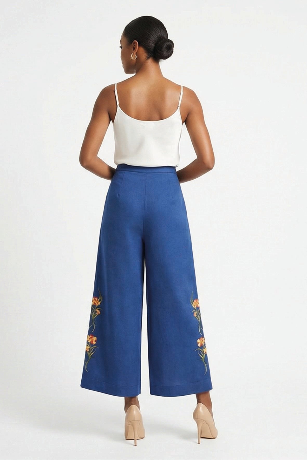 Fanm Mon Arel Pant back view on model featuring a high-rise waist, wide legs and floral embroidery along the outer legs