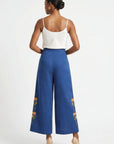 Fanm Mon Arel Pant back view on model featuring a high-rise waist, wide legs and floral embroidery along the outer legs