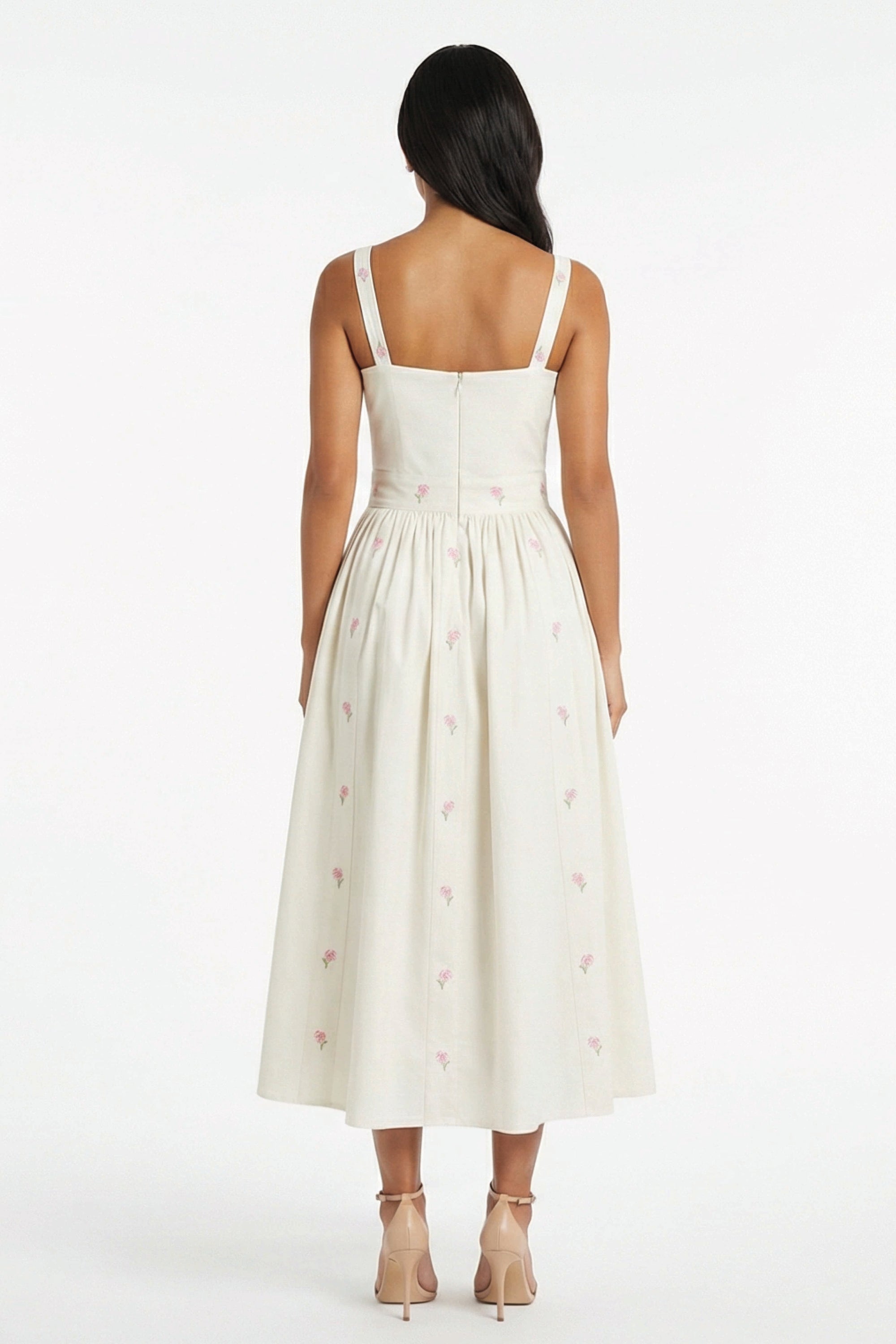 Back view of the Fanm Mon Arya Dress showcasing embroidered hydrangea details and a full midi silhouette.
