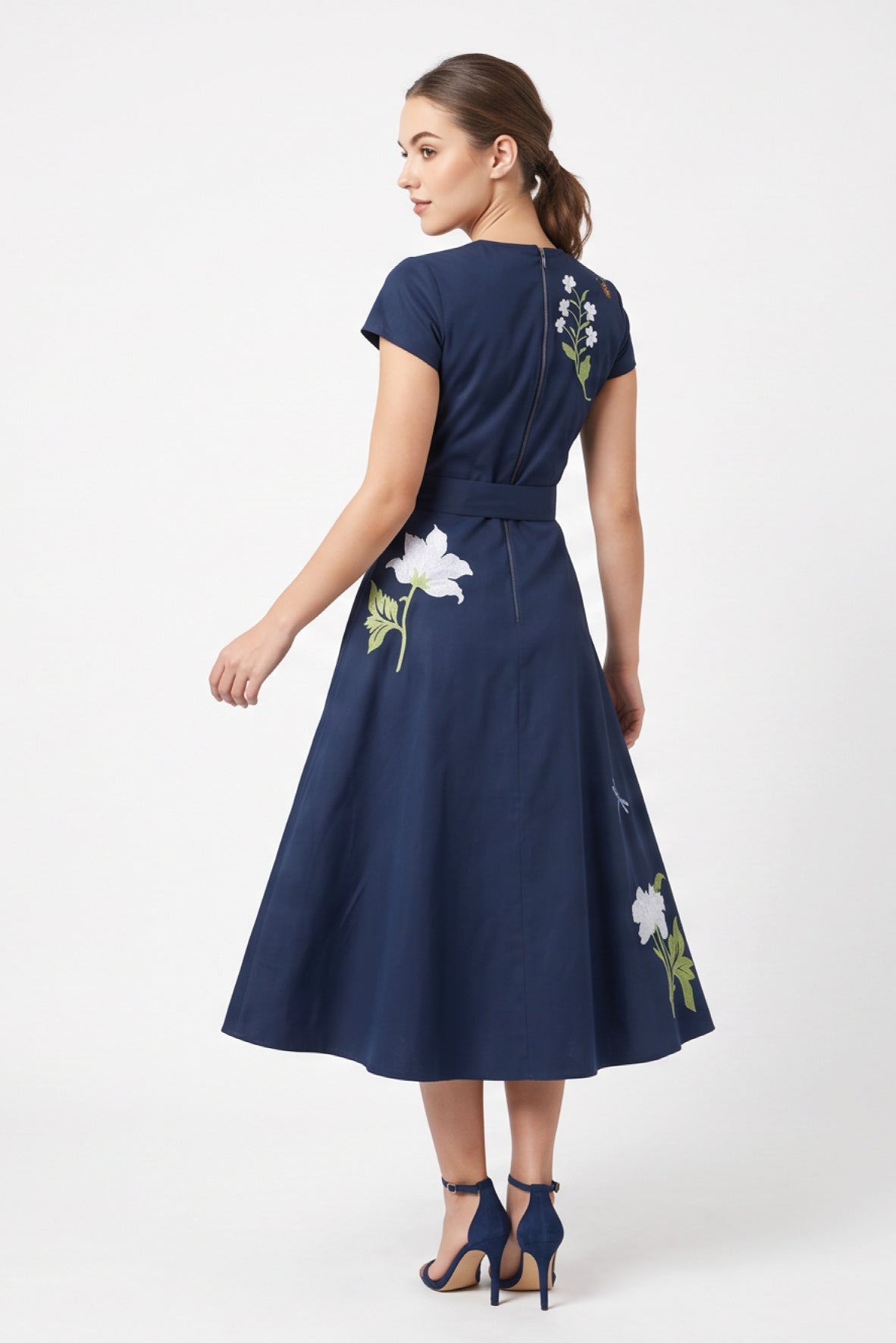 Back view of the Fanm Mon Burma Dress showcasing the fitted bodice, concealed back zipper, removable waist tie, embroidered floral detailing, and flowing A-line midi skirt.