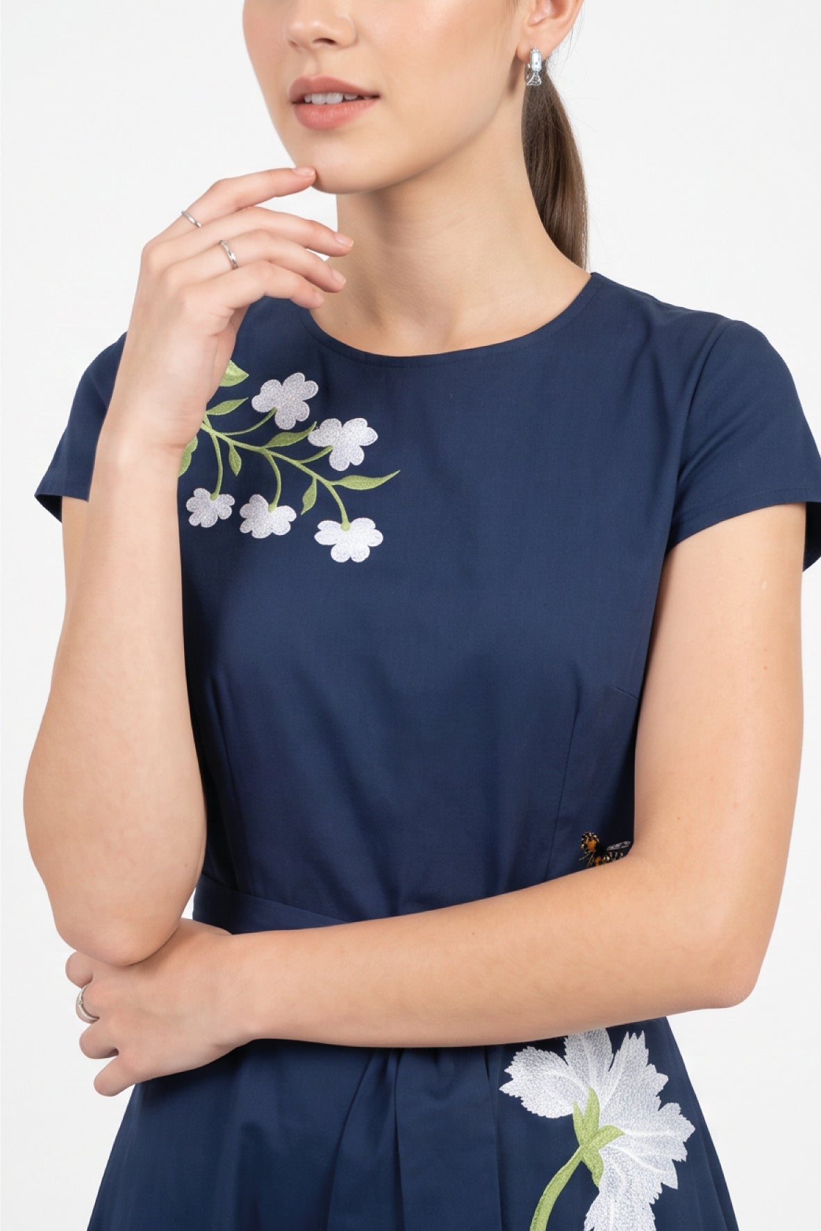 Close-up of the Fanm Mon Burma Dress highlighting the hand-embroidered jasmine blossoms, anemone embroidery, and intricate botanical detailing across the bodice.