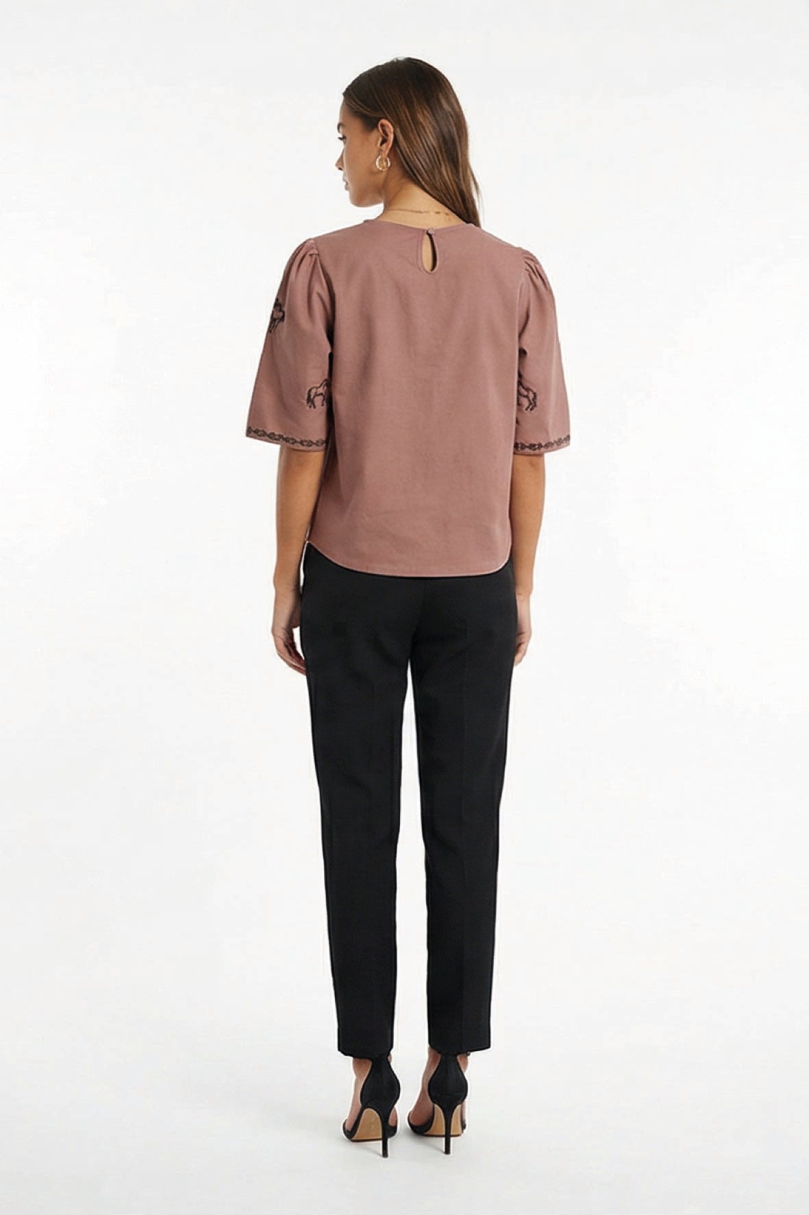 Backview of Model in Cait Blouse in Espresso showcasing puff sleeves and back keyhole button detail.