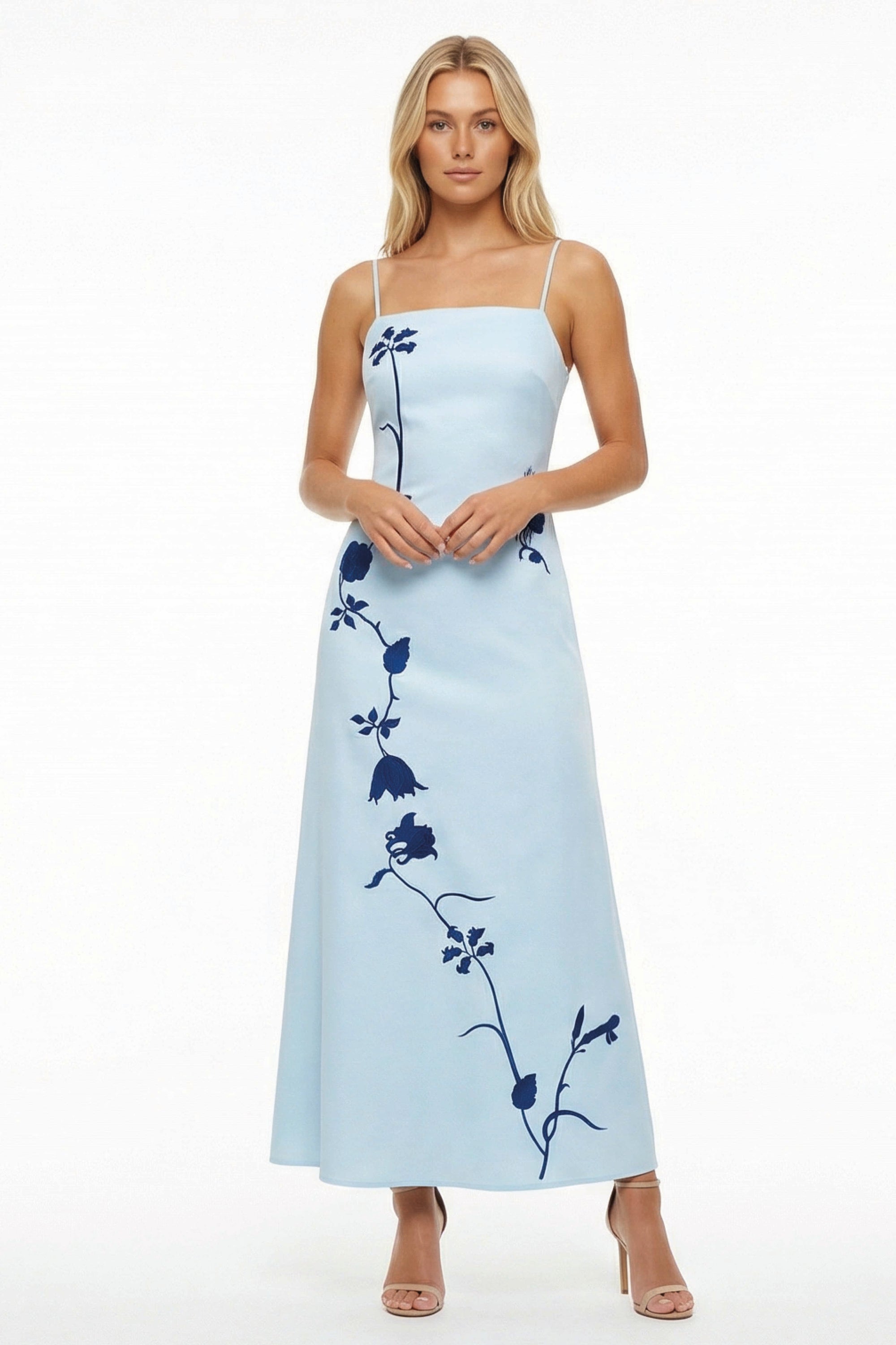 Model in elegant A-line Carmen Dress adorned with sweeping botanical embroidery, designed for summer celebrations and unforgettable occasions.