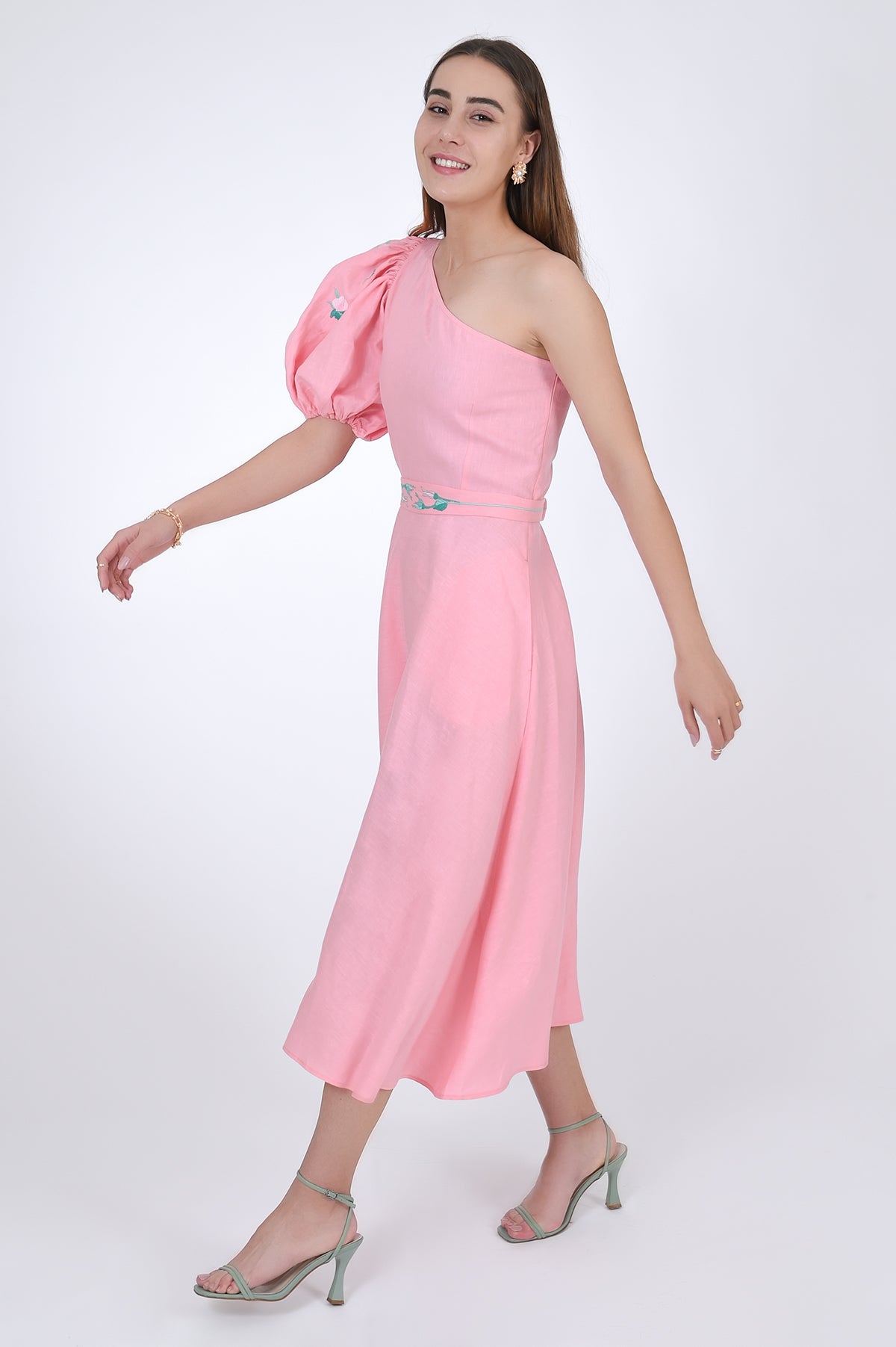 Fanm Mon Ayisha Midi Linen one shoulder Dress, side view with movement. Featuring a puff sleeve one shoulder design with embroidered floral pattern. 