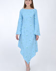Fanm Mon Choupet Asymmetrical Linen dress, front view.  Features long bell sleeves,  a boat neckline and hits mid length. Detailed with intricate floral-inspired embroidery a Fanm Mon signature. 
