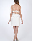 Arel Linen Mini Spaghetti Strap Dress featuring open back detail and tie feature in back (back view).
