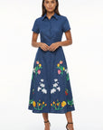 Fanm Mon Elena Dress featuring hand-placed tulip, jasmine, and lily embroidery, short sleeves, shirt collar, covered button front, and midi-length silhouette.