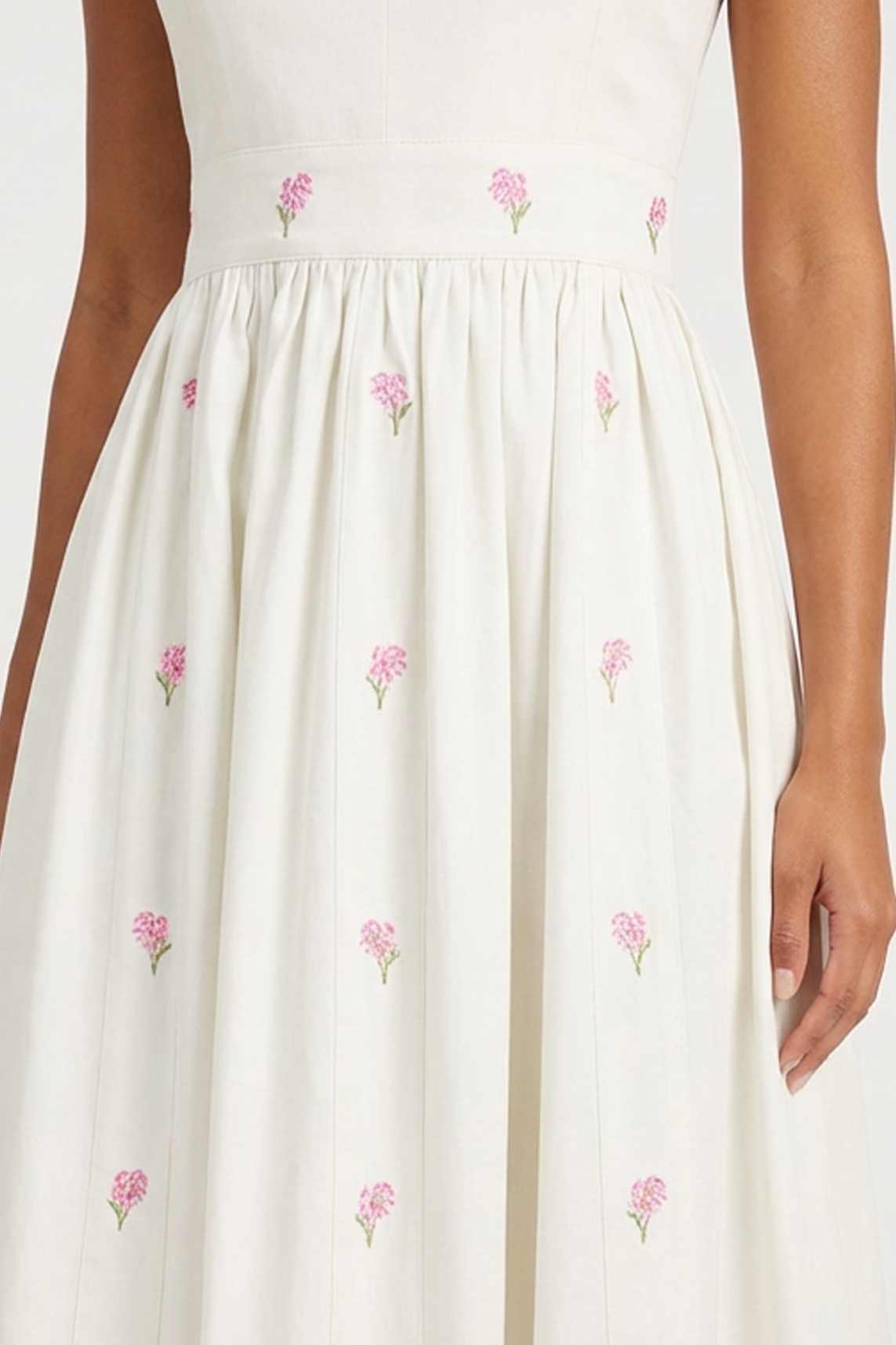 Close-up of the Arya Dress highlighting delicate hand-placed hydrangea embroidery scattered throughout the skirt.