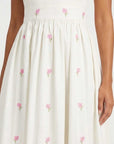 Close-up of the Arya Dress highlighting delicate hand-placed hydrangea embroidery scattered throughout the skirt.