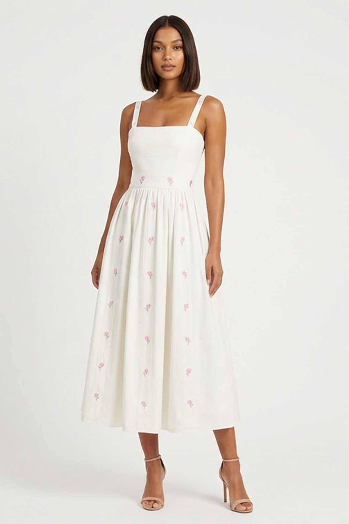Model in Arya Dress, a romantic midi dress adorned with delicate hydrangea embroidery, designed for summer celebrations and timeless occasion dressing.