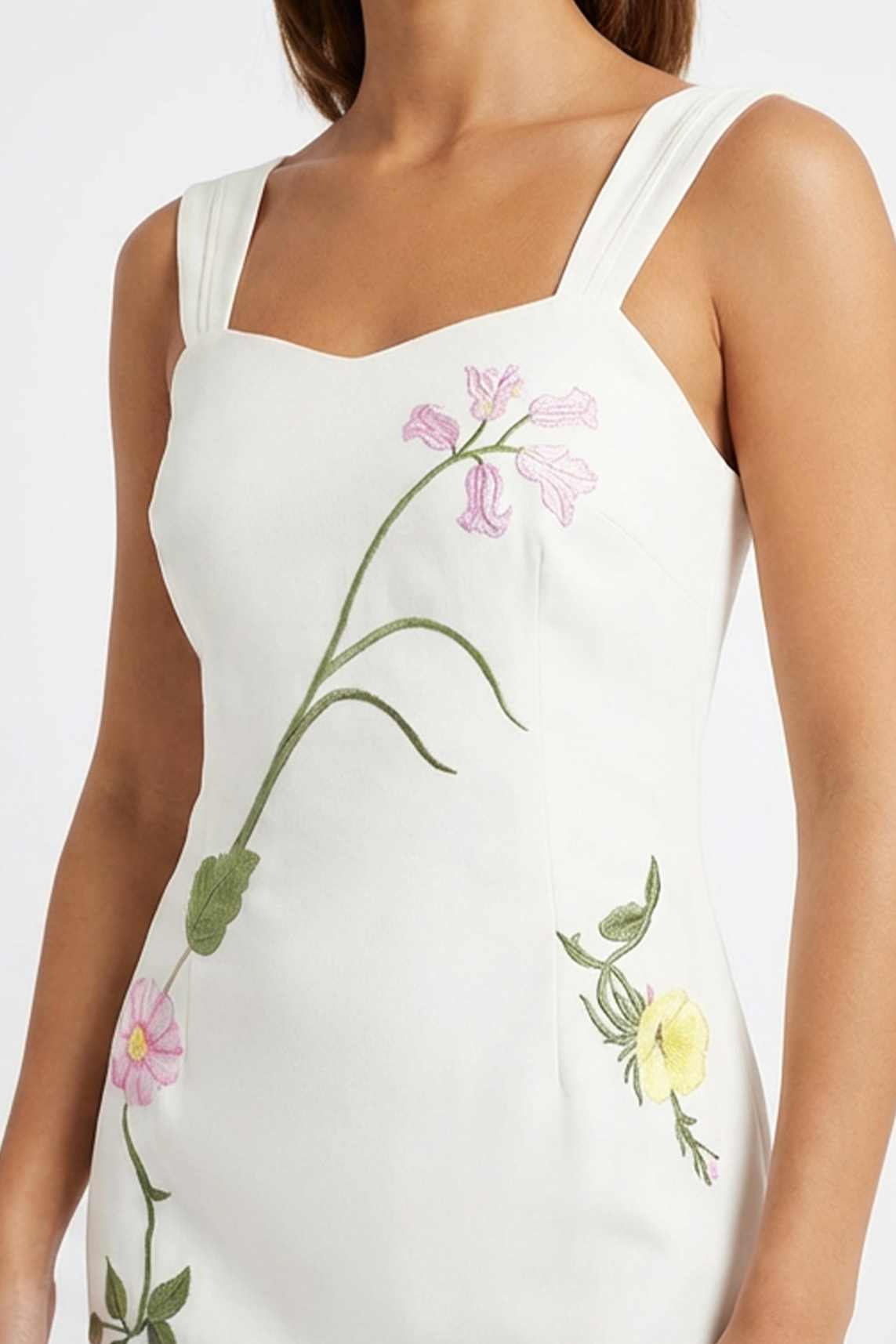 Close-up of the Bafra Dress highlighting intricate floral embroidery inspired by delicate garden blooms and trailing botanical vines.