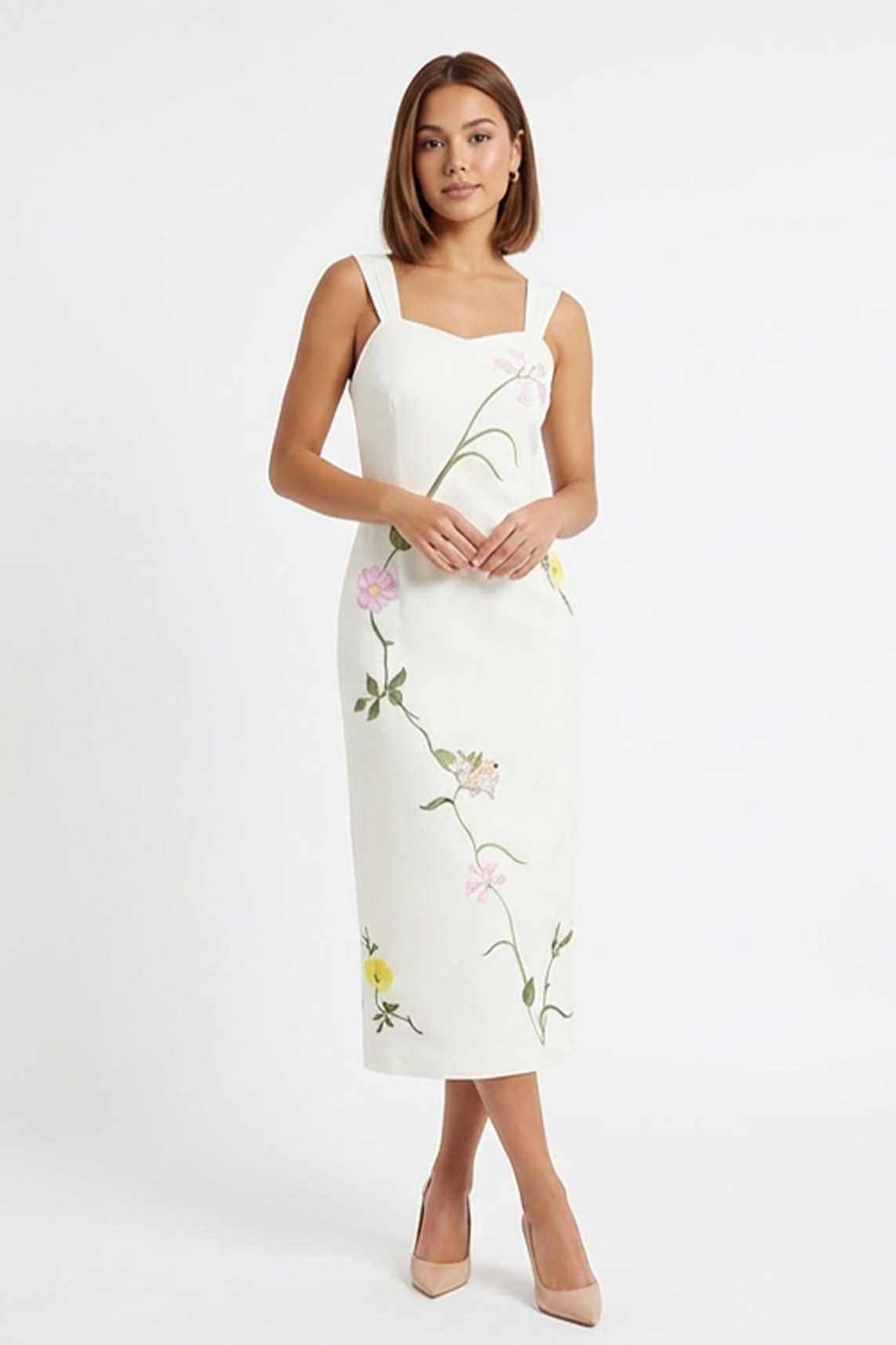 Model in the Bafra Dress a refined column dress adorned with winding botanical embroidery, designed for celebrations, special occasions, and timeless summer dressing.