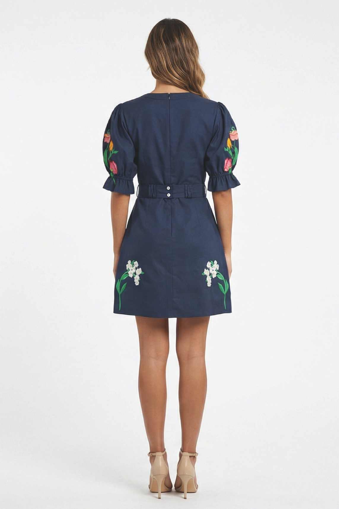 Back view of the Fanm Mon Cansel Dress featuring puff sleeves, removable belt detail, and embroidered floral accents.