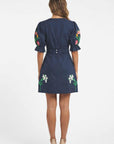 Back view of the Fanm Mon Cansel Dress featuring puff sleeves, removable belt detail, and embroidered floral accents.