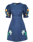 Cansel Dress by Fanm Mon featuring hand-placed tulip and jasmine embroidery, puff sleeves, removable belt, and A-line silhouette.