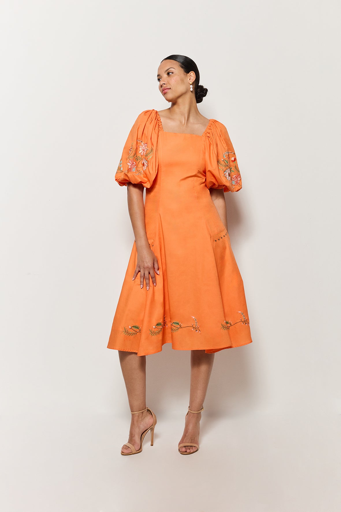 Frontview of Model in Fanm Mon's Cacem Dress showcasing puff sleeves and embroidery details. 