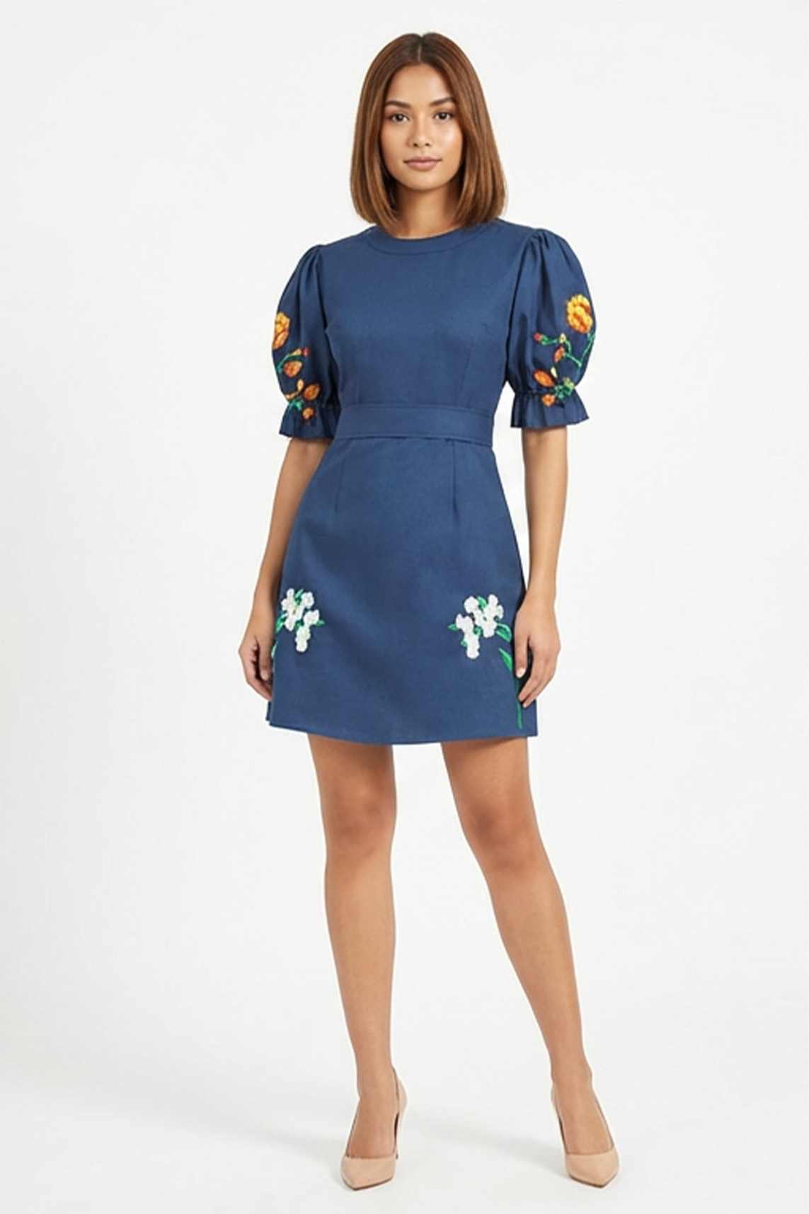 Model wearing the Fanm Mon Cansel Dress with embroidered puff sleeves, crew neckline, and floral embroidered skirt.