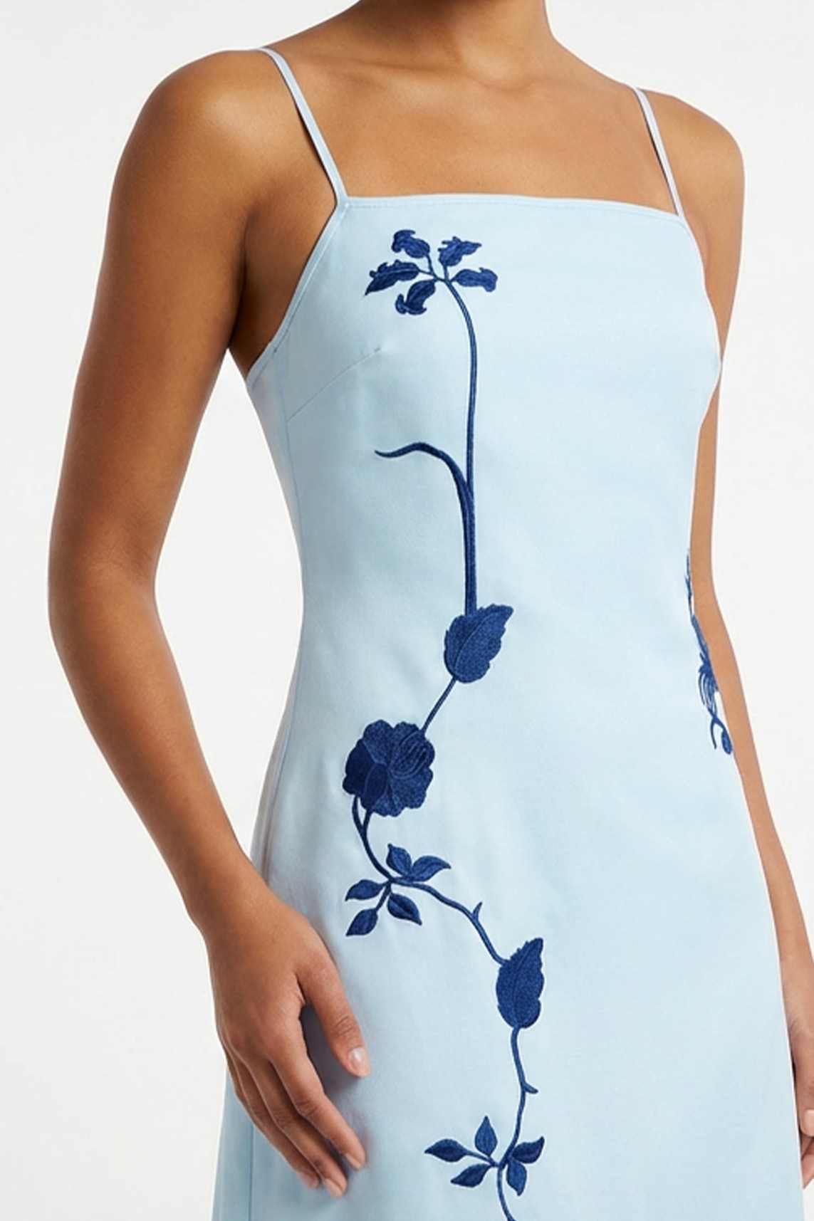 Close-up of the Carmen Dress highlighting intricate floral vine embroidery inspired by climbing garden blooms.