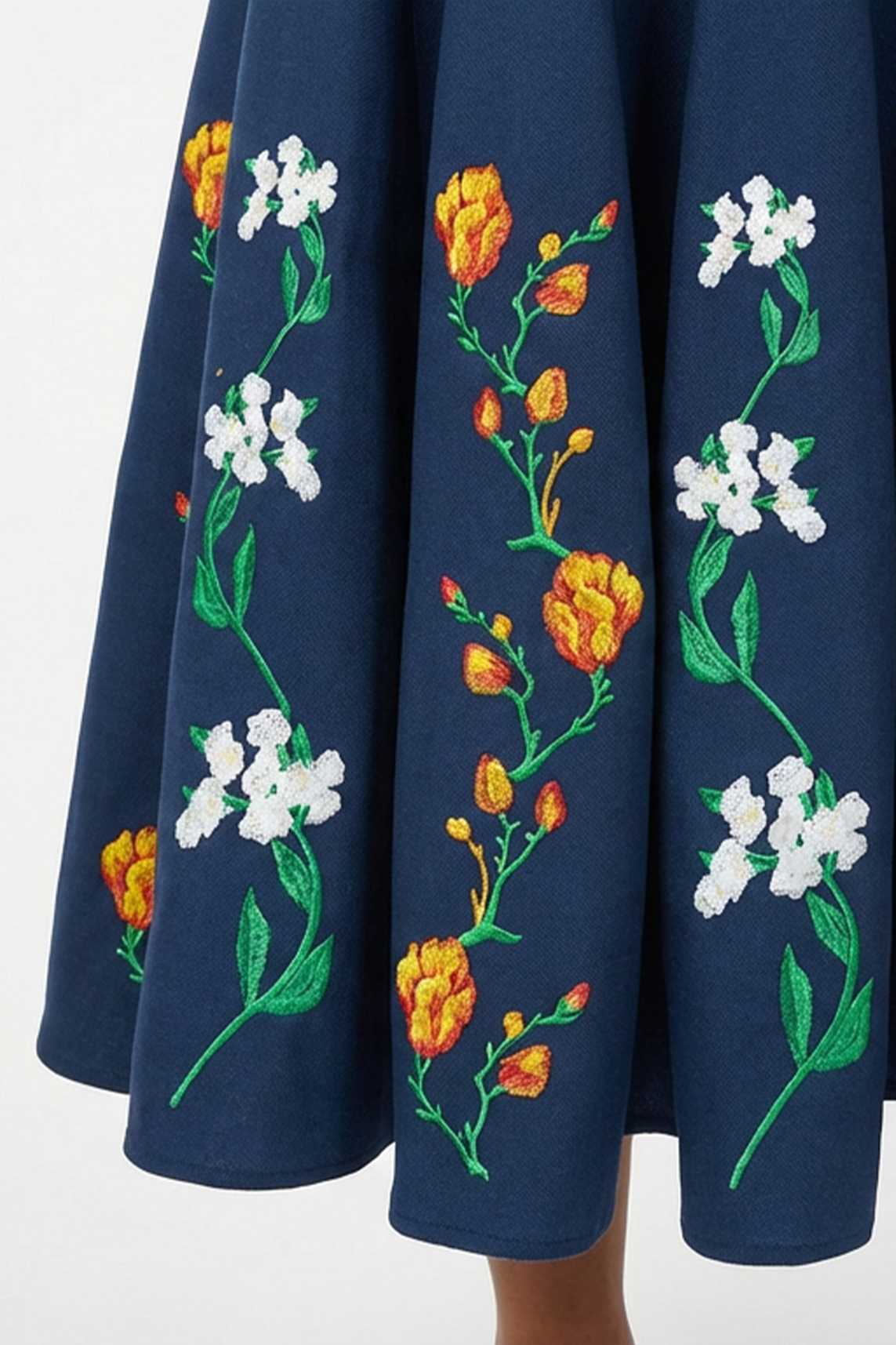 Close-up of hand-placed tulip and jasmine embroidery with intricate botanical detailing on the Erva Dress.