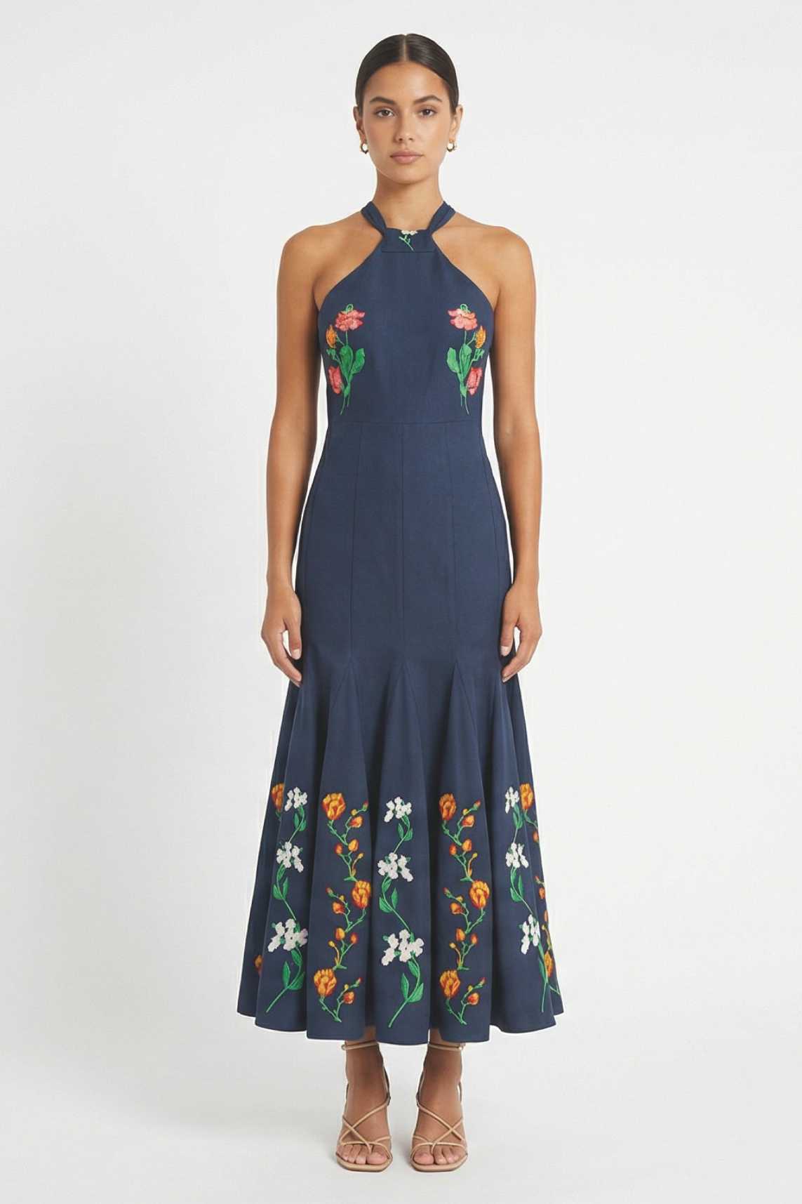 Front view ofErva Dress showcasing  embroidered halter-neck dress with floral embroidery framing the bodice and hem.
