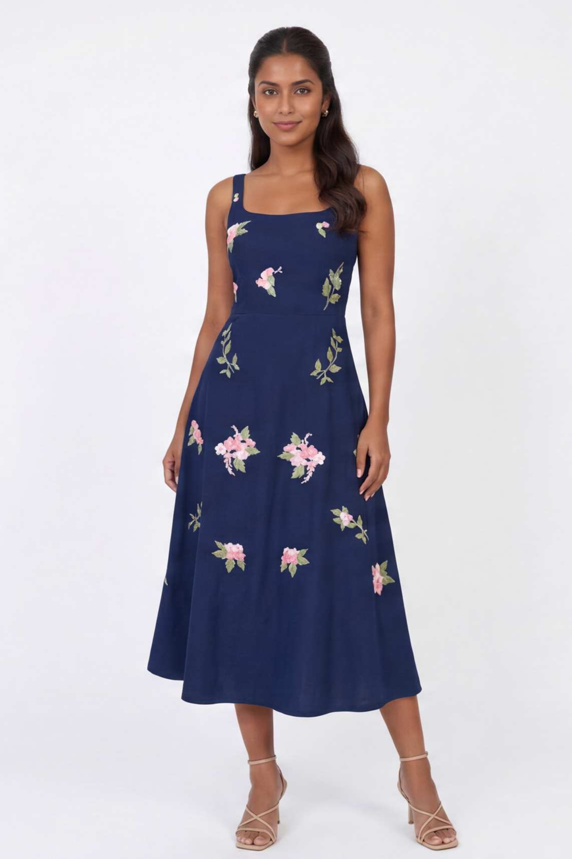 Model wearing the Fanm Mon Fisayo Dress with climbing rose embroidery, structured square neckline, and softly flared midi skirt against a neutral studio background.