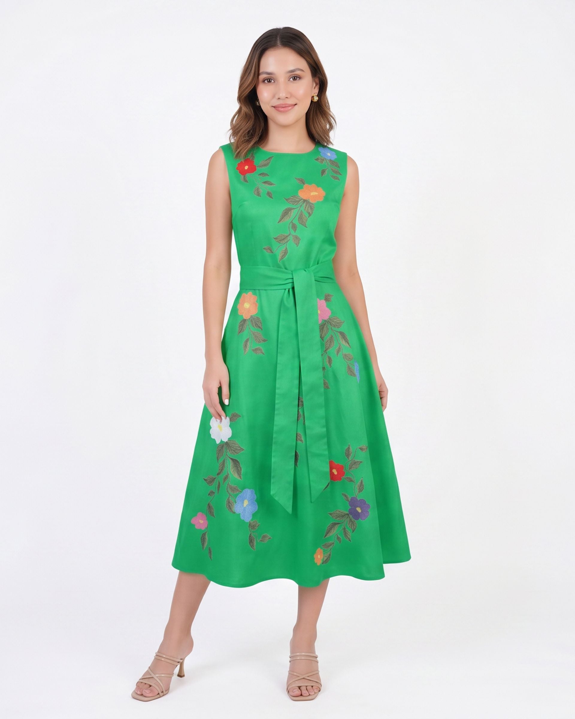 Model wearing the Fanm Mon Jules Dress with floral vine embroidery, sleeveless round neckline, self-tie waist belt, and elegant midi silhouette in front view against a neutral background.