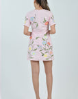 Model wearing the Fanm Mon Light Pink Joe Dress featuring hand-placed cosmos flower, poppy, and buttercup embroidery on a tailored mini silhouette against a neutral  background.