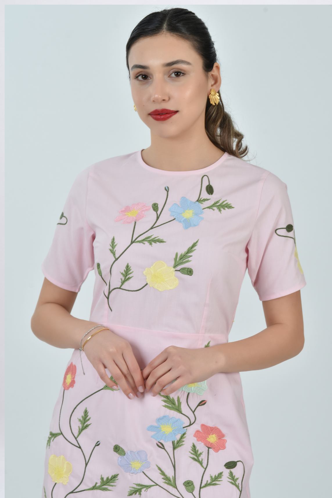 Detailed view of the Fanm Mon Joe Dress embroidery featuring cosmos blooms, wild poppies, buttercups, and trailing meadow vines on the bodice and skirt.
