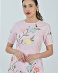 Detailed view of the Fanm Mon Joe Dress embroidery featuring cosmos blooms, wild poppies, buttercups, and trailing meadow vines on the bodice and skirt.