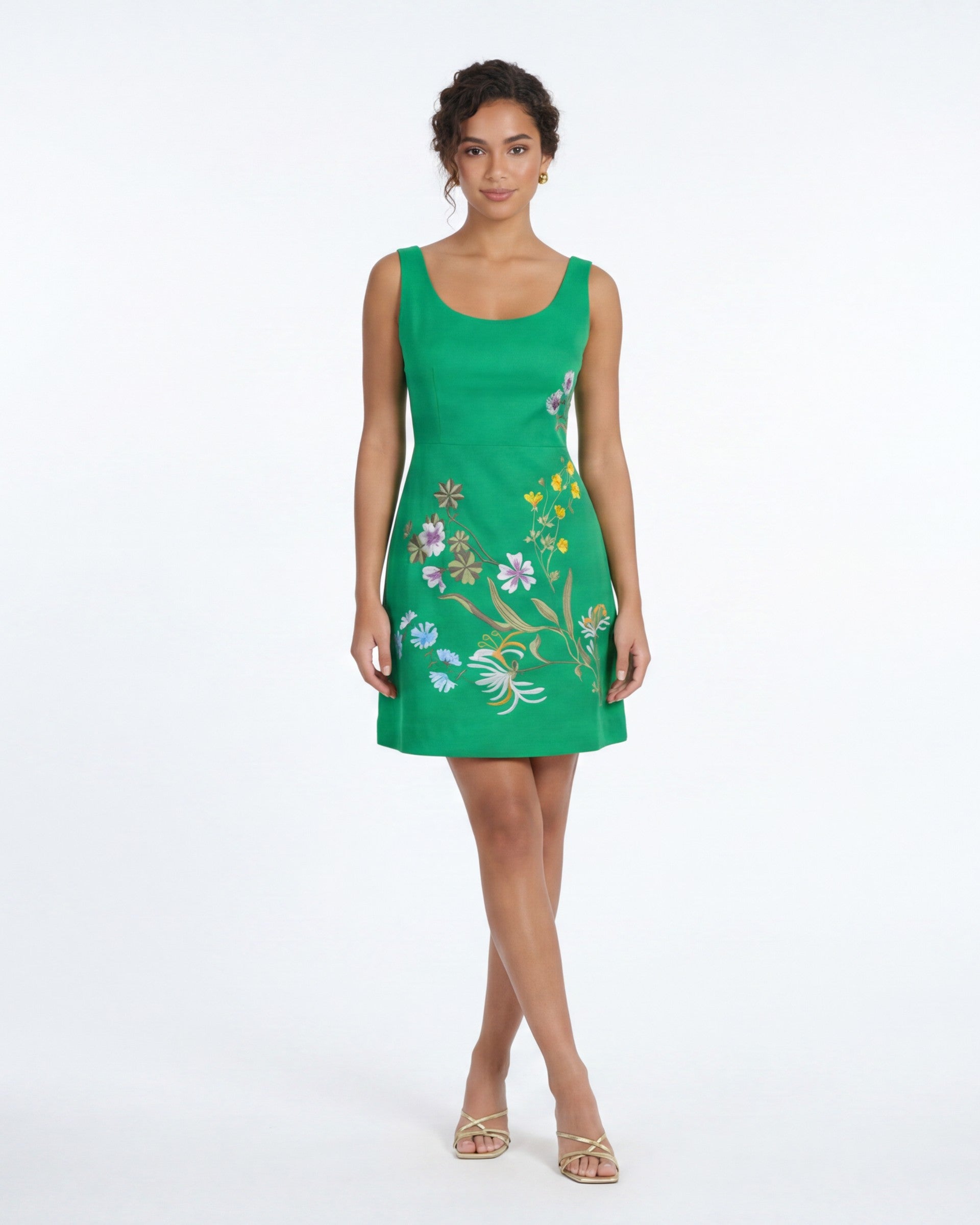 Model wearing the Fanm Mon Kelsie Dress featuring wildflower embroidery, scoop neckline, sleeveless tailored silhouette, and mini length in front view against a neutral studio background