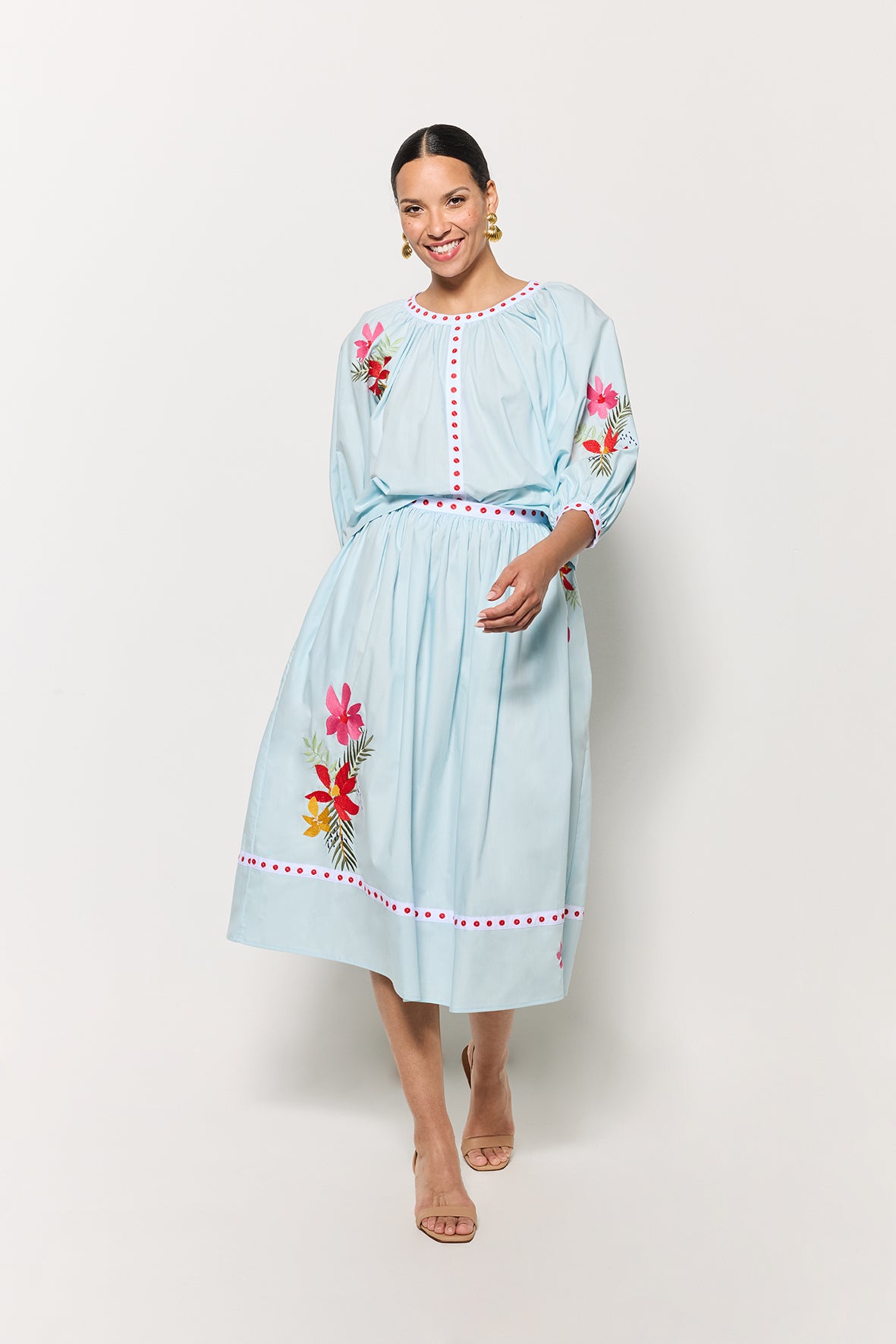 Model styled in the Kronso Blouse and Skirt Set, adorned with delicate floral embroidery on both pieces, set against a clean white backdrop.