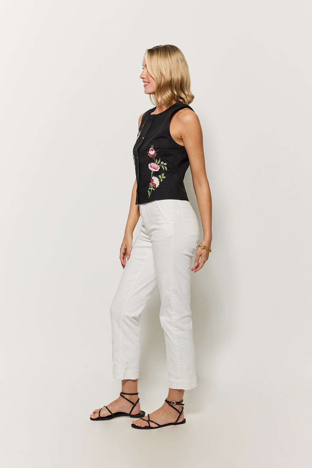 Linares button front blouse by Fanm Mon, sleeveless top with floral embroidery, side view.