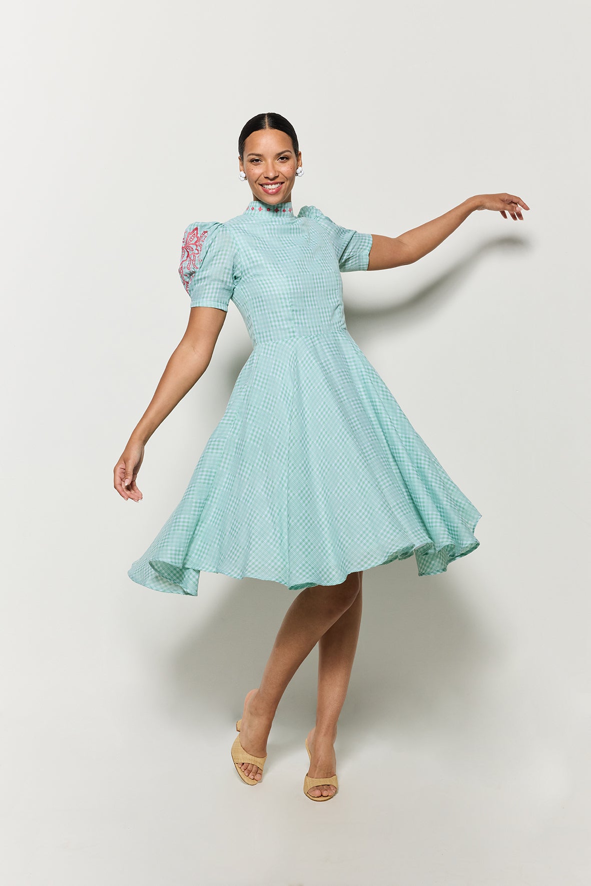 Showcasing the Movement of Lipno Dress in Green Checker Plaid with pink floral embroidery details