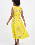 Back View of the Nosa Dress showcasing movement of the dress and featuring floral embroidery details inspired by tulips