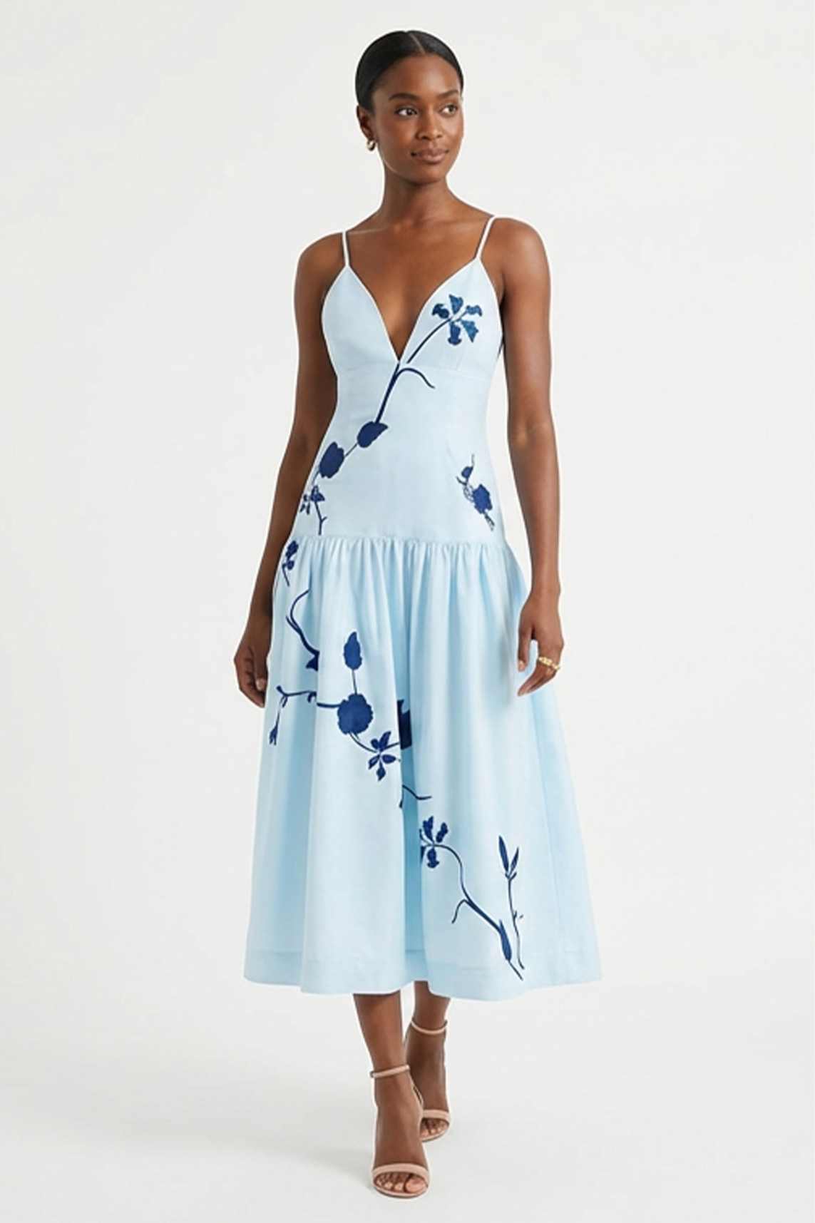 Model wearing the Fanm Mon Paola Dress with floral embroidery, V-neckline, and elegant midi silhouette.