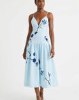 Model wearing the Fanm Mon Paola Dress with floral embroidery, V-neckline, and elegant midi silhouette.